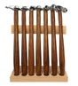 7-piece professional hammer set with polished steel heads and cherry wood handles on wooden storage stand for jewelry making