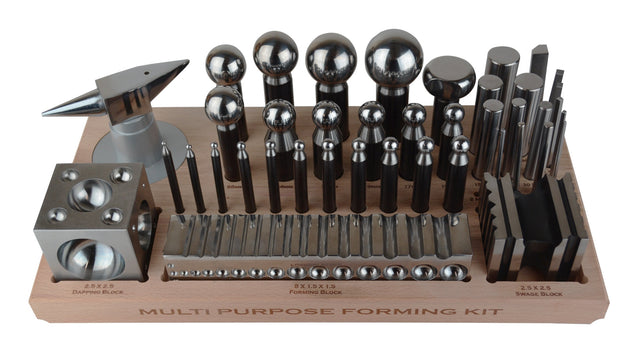 43-piece multi-purpose metal forming dapping set with block, anvil, swage, and punches on wooden tray for jewelry making and metalworking.